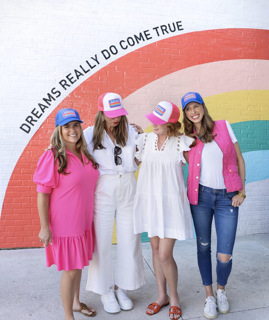Group branding portrait in front of a rainbow mural