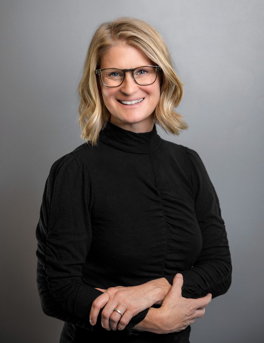 Business headshot of a woman in a black top