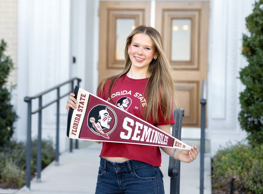 Senior portrait holding a Florida State Seminoles pennant