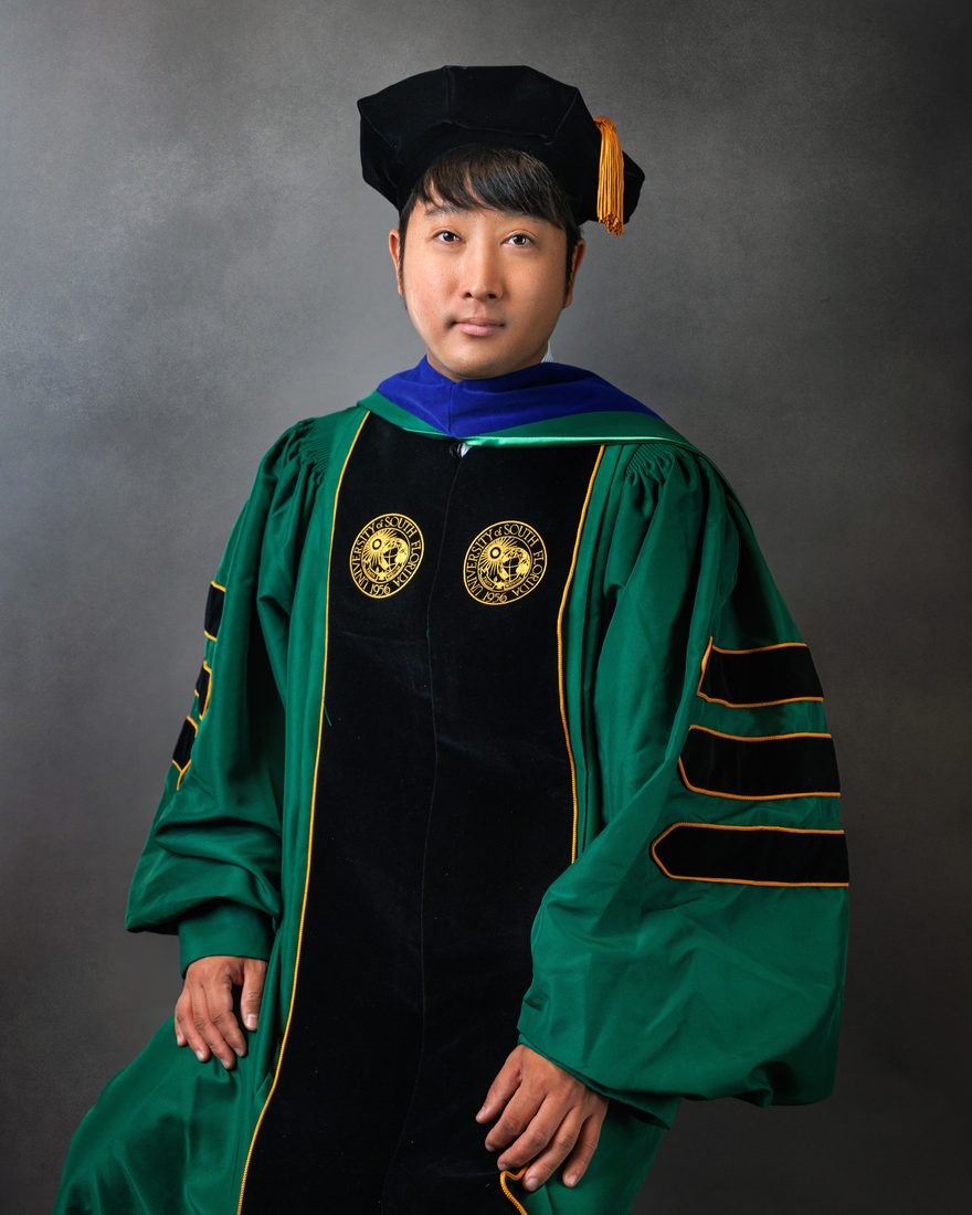 Graduate portrait in doctoral cap and gown